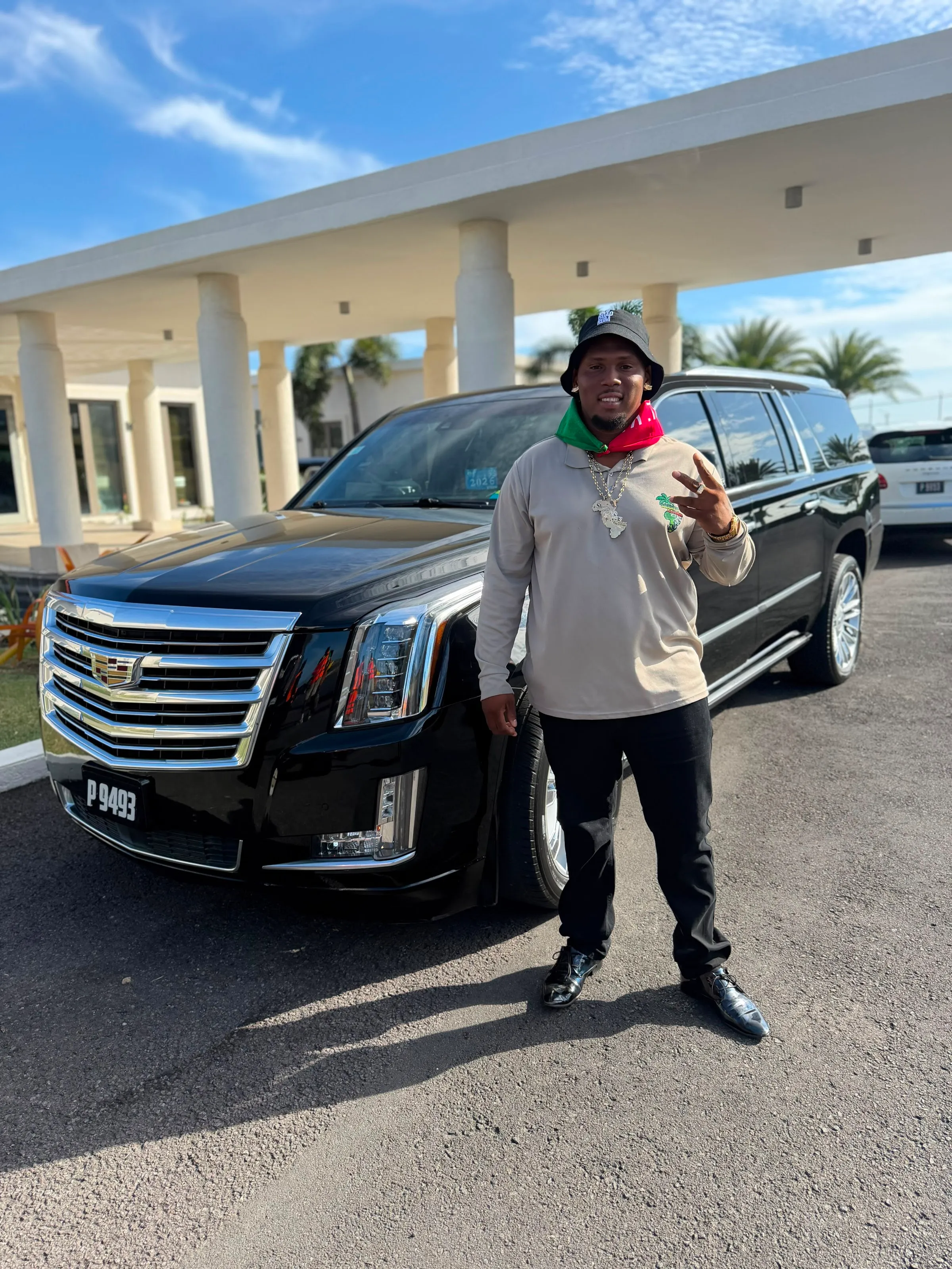 Shane standing beside his black Escalade